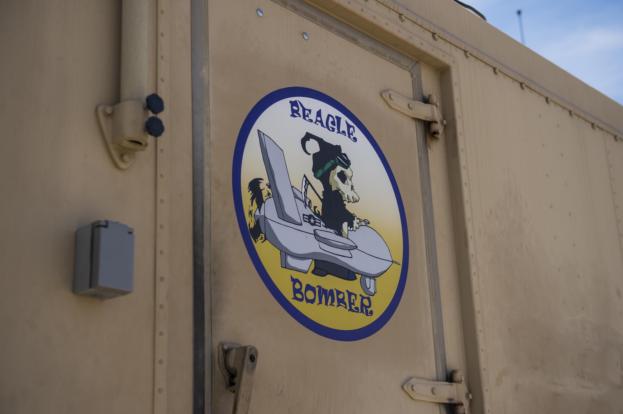 A decal is pictured on a Ground Control Station at Holloman Air Force Base, N.M. June 6, 2017. Under Col. Houston Cantwell, 49th Wing commander’s initiative, Holloman’s GCS yard is undergoing an artistic upgrade. This upgrade has led to the creation of 12 decals and application of 10 decals on the yard’s GCSs. The decals, created in the spirit of World War II nose art, are used to raise morale among Holloman’s Airmen. (U.S. Air Force photo by Airman 1st Class Alexis P. Docherty) 