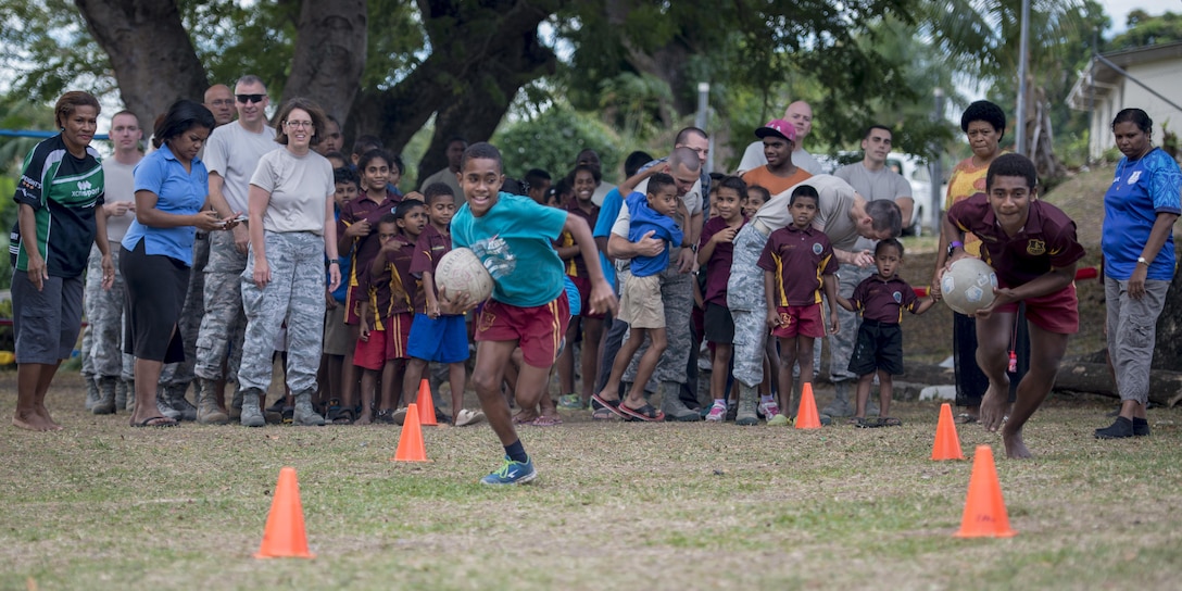 Two Fijian boys race against time during an obstacle course competition where they paired up with a U.S. service member on each team and fought the clock to get the whole team through the course before time ran out during a sports day community engagement activity at the Lautoka School for Special Education in Lautoka, Fiji, July 14, 2017. The service members are in Lautoka as part of Pacific Angel 2017 where they’re working with the Fijian government to provide humanitarian assistance and subject matter expert exchanges July 11 to 24. (U.S. Air Force photo/Tech. Sgt. Benjamin W. Stratton)