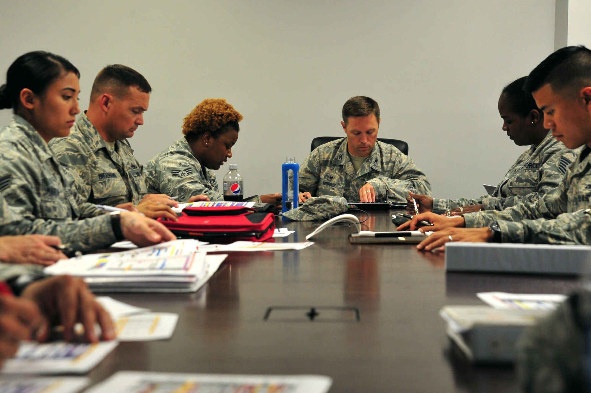 U.S. Airmen assigned to the 20th Maintenance Group discuss the base’s F-16CM Fighting Falcons during a meeting at Shaw Air Force Base, S.C., July 12, 2017. The weekly meeting allows Airmen from various sections to update each other on the status of each F-16 and address any areas in need of attention during the past week. (U.S. Air Force photo by Airman 1st Class Kathryn R.C. Reaves)
