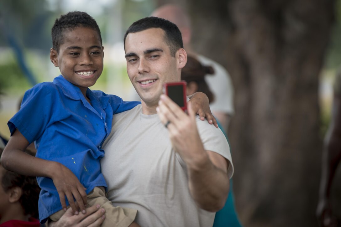 U.S. Air Force Senior Airman Benjamin Haase, a physical therapy assistant with the 673rd Medical Operations Squadron at Joint Base Elmendorf-Richardson, Alaska, takes a selfie with a Fijian boy during a sports day community engagement activity at the Lautoka School for Special Education in Lautoka, Fiji, July 14, 2017. The event afforded U.S. service members participating in Pacific Angel 2017 an opportunity to play with nearly 50 students in various field day-esque games designed to bring the two nations closer as allies and friends. (U.S. Air Force photo/Tech. Sgt. Benjamin W. Stratton)