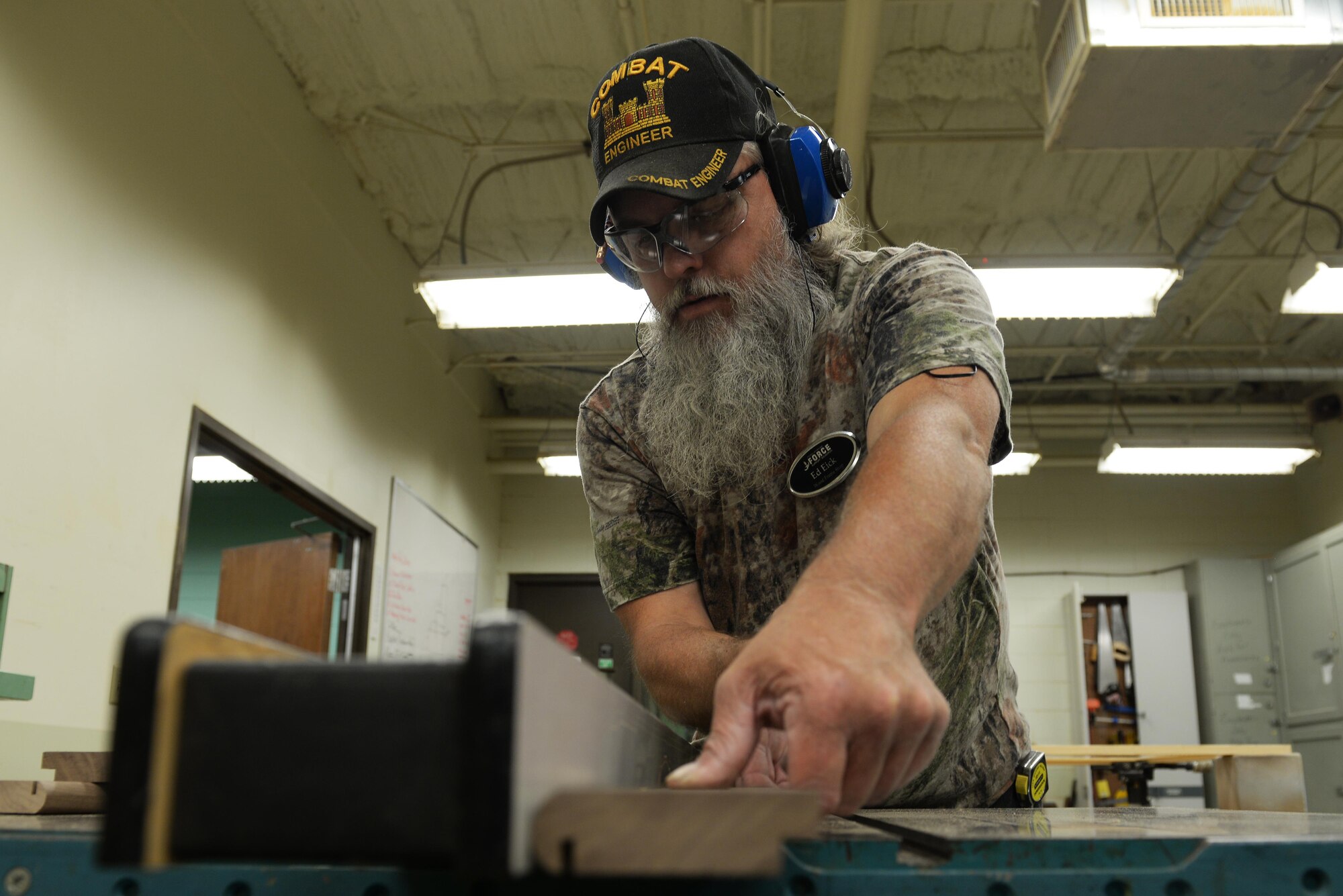 Ed Eick, 19th Force Support Squadron wood and frame shop worker, saws a slot in a piece of wood to allow glass to be placed inside, July 6, 2017, at Little Rock Air Force Base, Ark. Eick said that after 27 years in the military he puts a lot of heart and care into his work. (U.S. Air Force photo by Airman Rhett Isbell)
