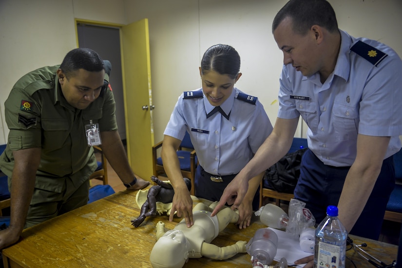 Republic of Fiji Military Forces Sgt. Natoga Anitelu, left, a medical services technician, discusses the best ways to clear an infant’s airway with U.S. Air Force Capt. Paola Rosa, center, and U.S. Air Force Maj. Scott Stewart, right, during a subject-matter expert exchange (SMEE) at a health care center in Ba, Fiji, July 11, 2017. These SMEE events afforded multilateral international participants and non-governmental organizations opportunities to share knowledge and improve each other’s skillsets. The events kicked-off Pacific Angel 2017 in Fiji, which lasts until July 24, 2017. (U.S. Air Force photo/Capt. Samantha Morrison)