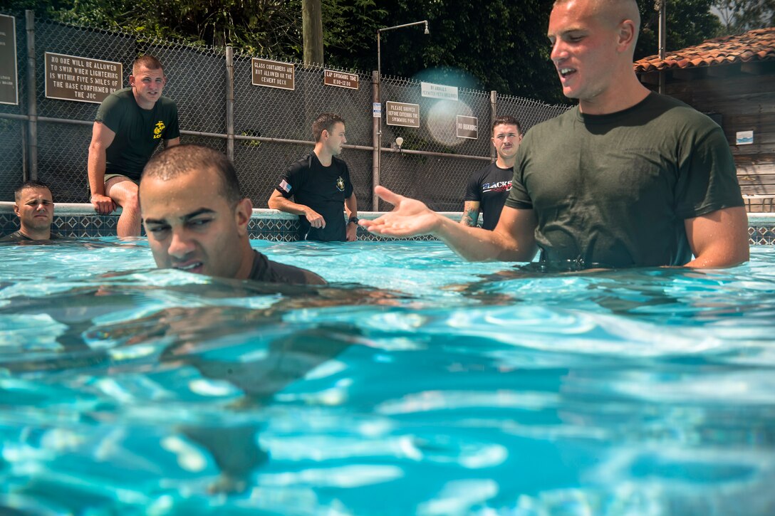 U.S. Marines with Special Purpose Marine Air-Ground Task Force – Southern Command conduct water survival training with U.S. Army soldiers from JTF-Bravo Medical Element at Soto Cano Air Base, June 13, 2017. This week-long training class went over different survival techniques, swimming tips, uniform flotation methods and physical training. (U.S. Air National Guard photo by Master Sgt. Scott Thompson/released)