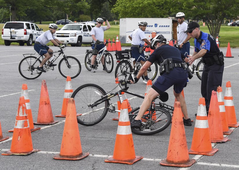 U.S. Air Force Airmen assigned to the 633rd Security Forces Squadron and officers from the Hampton Police Department practice maneuvering their bikes in limited space in Hampton, Va., June 6, 2017. In addition to bicycle maneuverability training, the Hampton Police Department helps the 633rd SFS with standardized field sobriety test, DUI procedures and radar training. (U.S. Air Force photo/Airman 1st Class Anthony Nin Leclerec)