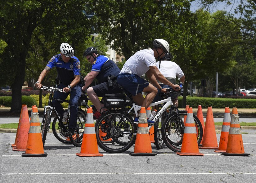 U.S. Air Force Airmen assigned the 633rd Security Forces Squadron and officers from the Hampton Police Department practice maneuvering their bikes in limited space in Hampton, Va., June 6, 2017. Bike patrols provide increased maneuverability during events such as concerts and airshows to help provide more effective security. (U.S. Air Force photo/Airman 1st Class Anthony Nin Leclerec)
