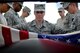 U.S. Air Force Airman 1st Class Angela Fairhurst, 20th Force Support Squadron honor guardsman, lifts a flag from a casket during funeral detail training at Shaw Air Force Base, S.C., July 18, 2017. Service members who participated in the 20th FSS Honor Guard attended an initial two-week training course. During this course, Airmen developed all honor guard drill movements and mastered key commands. (U.S. Air Force photo by Senior Airman Christopher Maldonado)