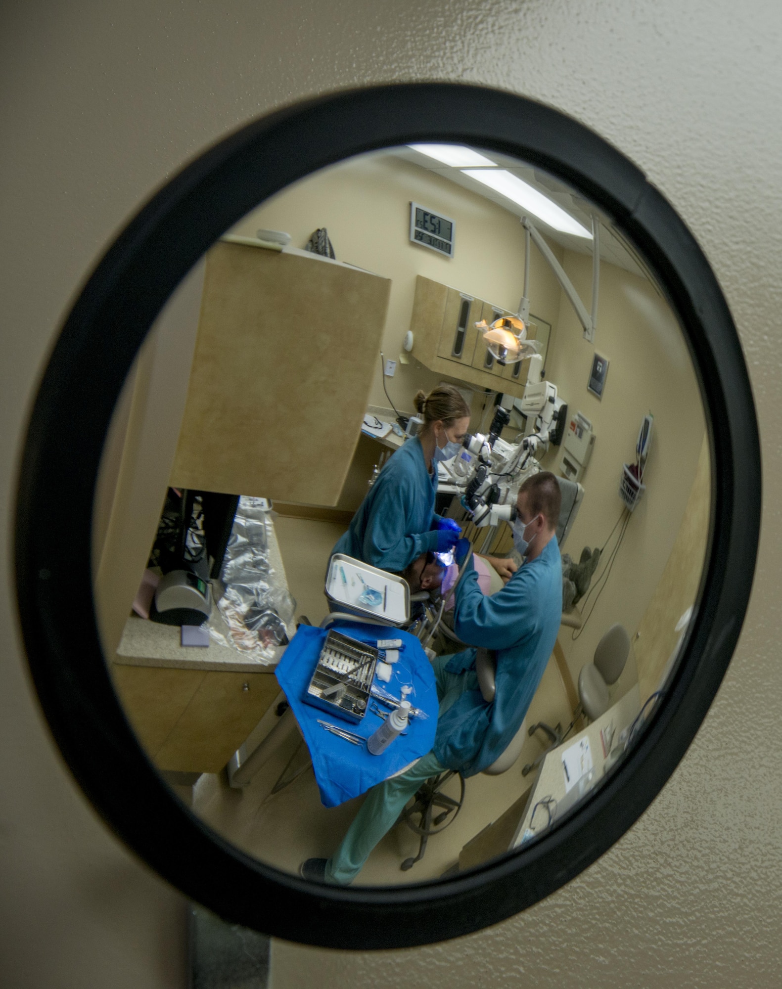 U.S. Air Force Maj. Kelly Ramey, left, an endodontist, and Senior Airman David Coleman, right, a dental assistant, both assigned to the 6th Dental Squadron, perform a root canal treatment at MacDill Air Force Base, Fla., July 11, 2017. After Ramey commissioned as a dentist, she specialized in endodontics. (U.S. Air Force photo by Senior Airman Mariette Adams)