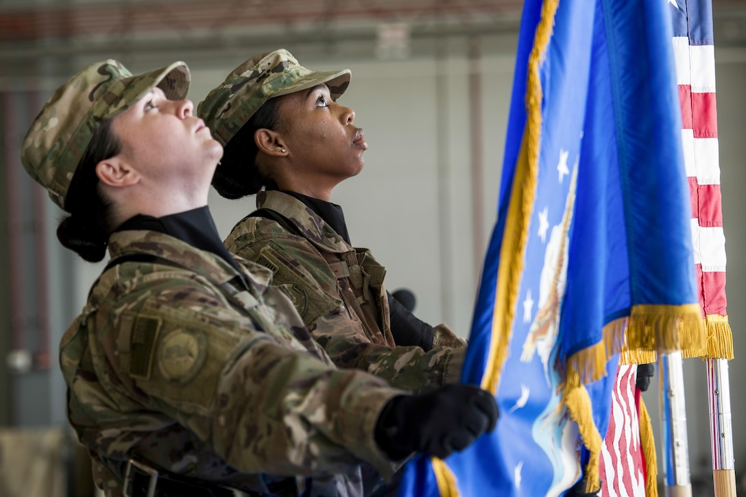 Bagram Honor Guard members set the Air Force and American flags in place during a change-of-command ceremony at Bagram Airfield, Afghanistan, July 14, 2017, for the 455th Expeditionary Aircraft Maintenance Squadron. Air Force photo by Staff Sgt. Benjamin Gonsier