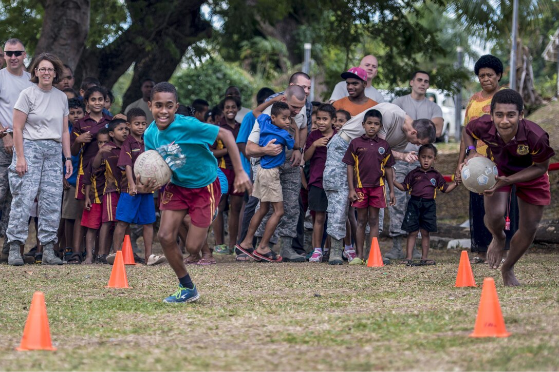 Two Fijian boys race during an event in which they partnered with U.S. service members at a school in Lautoka, Fiji, July 14, 2017. The service members are participating in Pacific Angel 2017, providing humanitarian assistance and subject matter expert exchanges through July 24. Air Force photo by Tech. Sgt. Benjamin W. Stratton