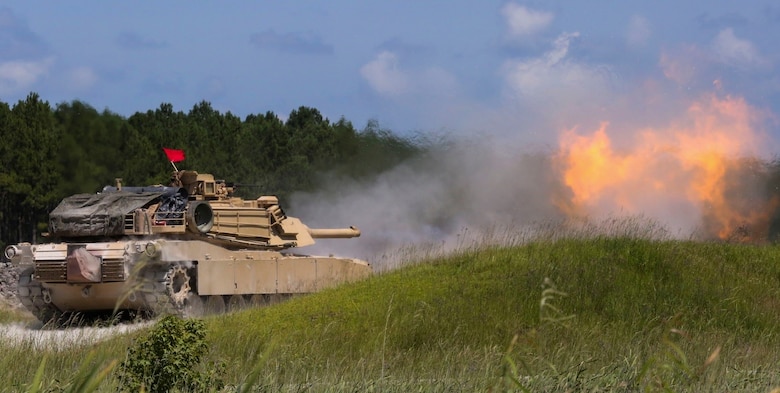An M1A1 Abrams battle tank fires a round at a simulated target during a combined arms range for Iron Wolf 17 at Camp Lejeune, N.C., July 14, 2017. Iron Wolf 17 is a multi-unit exercise designed to simulate battlefield conditions Marines may face while deployed. The tanks are from 2nd Tank Battalion, 2nd Marine Division. (United States Marine Corps photo by Cpl. Jon Sosner)