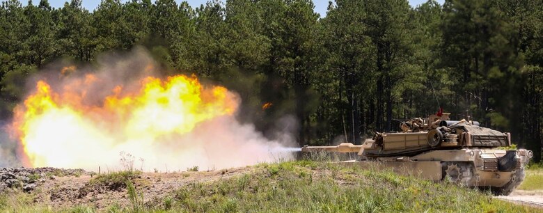 An M1A1 Abrams battle tank fires a round at a simulated target during a combined arms range for Iron Wolf 17 at Camp Lejeune, N.C., July 14, 2017. Iron Wolf 17 is a multi-unit exercise designed to simulate battlefield conditions Marines may face while deployed. The tanks are from 2nd Tank Battalion, 2nd Marine Division. (United States Marine Corps photo by Cpl. Jon Sosner)
