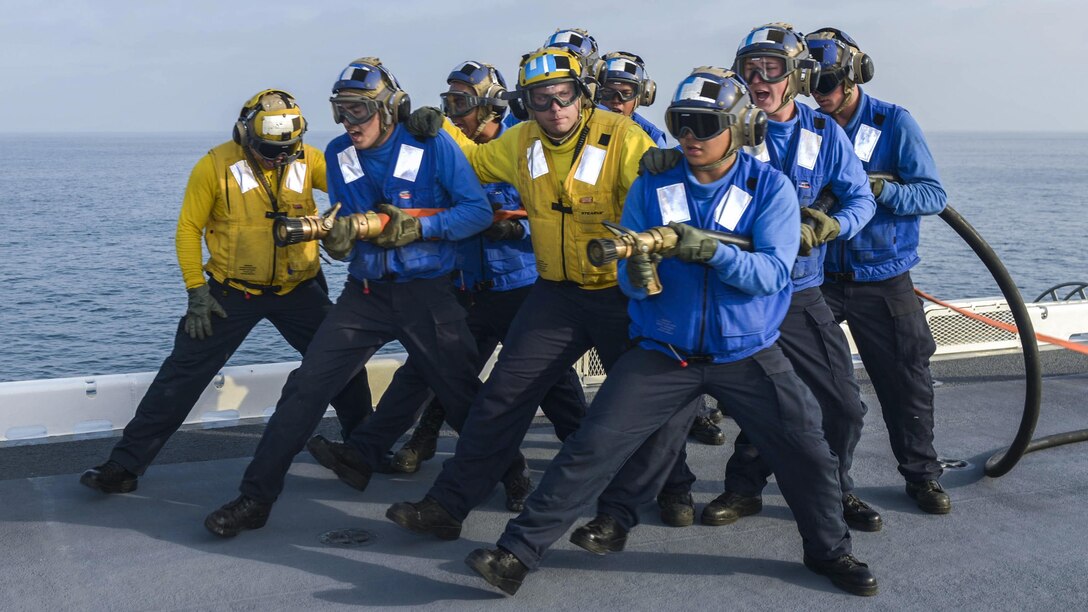 Sailors man hoses during a fire drill on the flight deck of the USS Essex in the Pacific Ocean, July 15, 2017. The amphibious assault ship is conducting sea trials off the coast of Southern California. Navy photo by Petty Officer 2nd Class Donavan K. Patubo