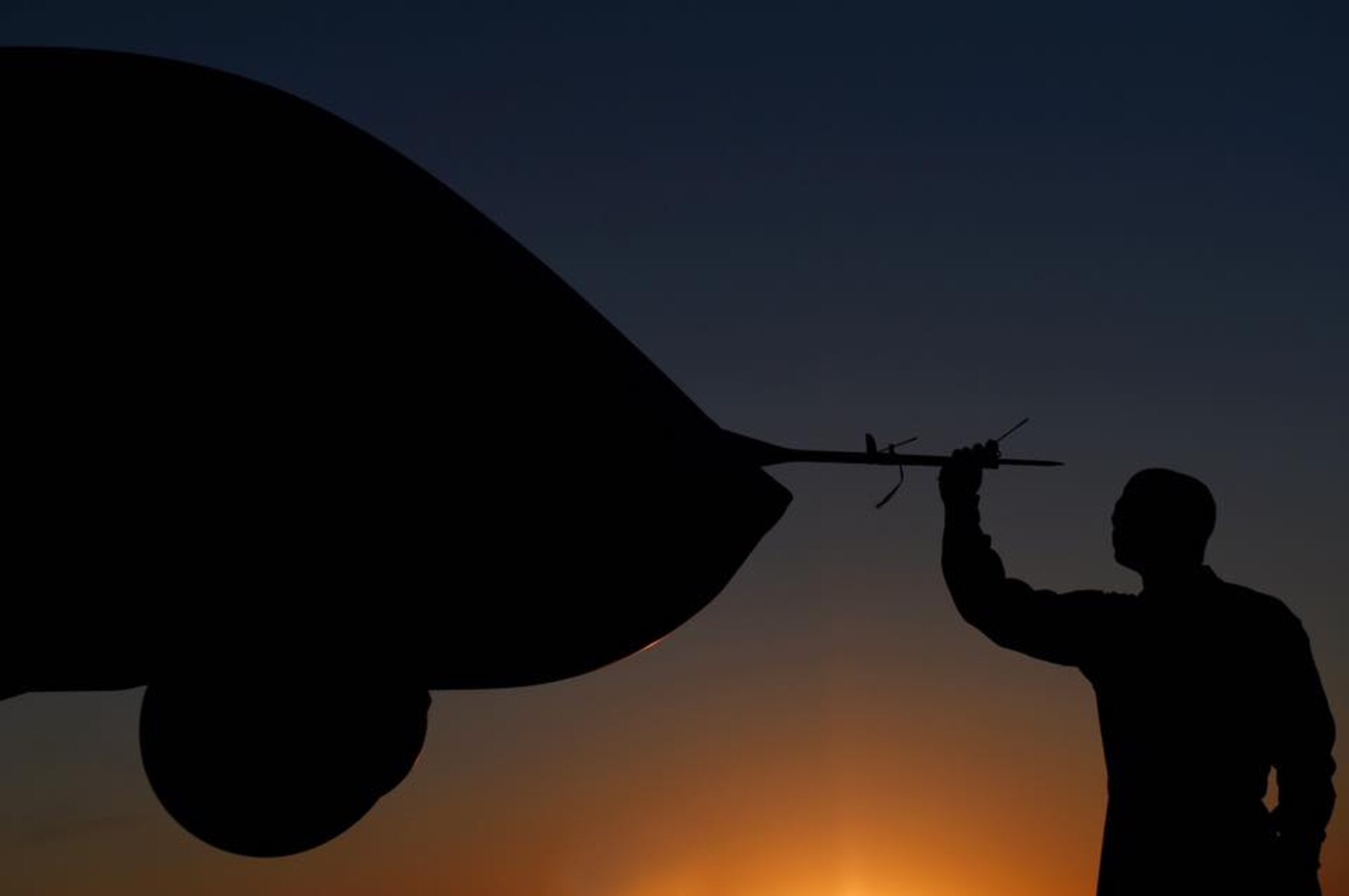 A maintainer prepares to push the MQ-9 Reaper back to the hangar July 15, 2017, after the close of the Lethbridge International Air Show in Alberta, Canada. The air show provided the opportunity for Airmen to dispel myths around the MQ-1 and MQ-9 enterprise. (U.S. Air Force photo/Master Sgt. Nadine Barclay) 