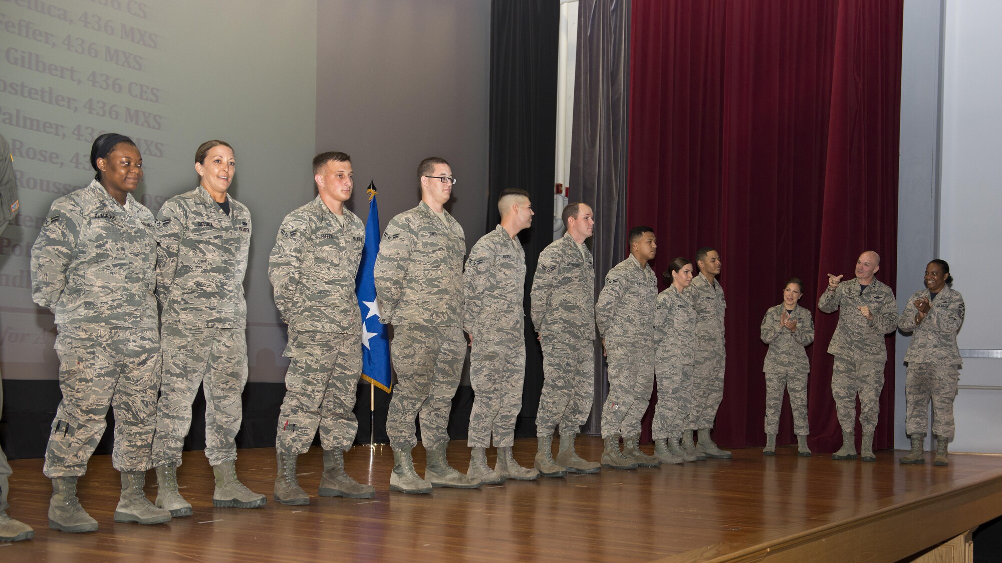 Gen. Carlton D. Everhart II, Air Mobility Command commander, and Chief Master Sgt. Shelina Frey, AMC command chief, surprise 11 Airmen with Below-the-Zone senior airman promotions July 14, 2017, at Dover Air Force Base, Del. These promotions allow the Airman to promote six months early. (U.S. Air Force photo by Senior Airman Zachary Cacicia)