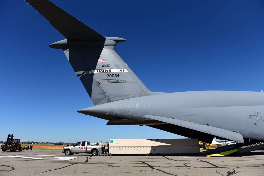 The MQ-9 Reaper model is off-loaded from a C-5M Supergalaxy July 13, 2017, at the Lethbridge International Air Show in Alberta, Canada. MQ-9s and other remotely piloted aircraft are not be flown over civilian airspace and must be broken down and transported via cargo aircraft. (U.S. Air Force photo/Senior Airman Christian Clausen)
