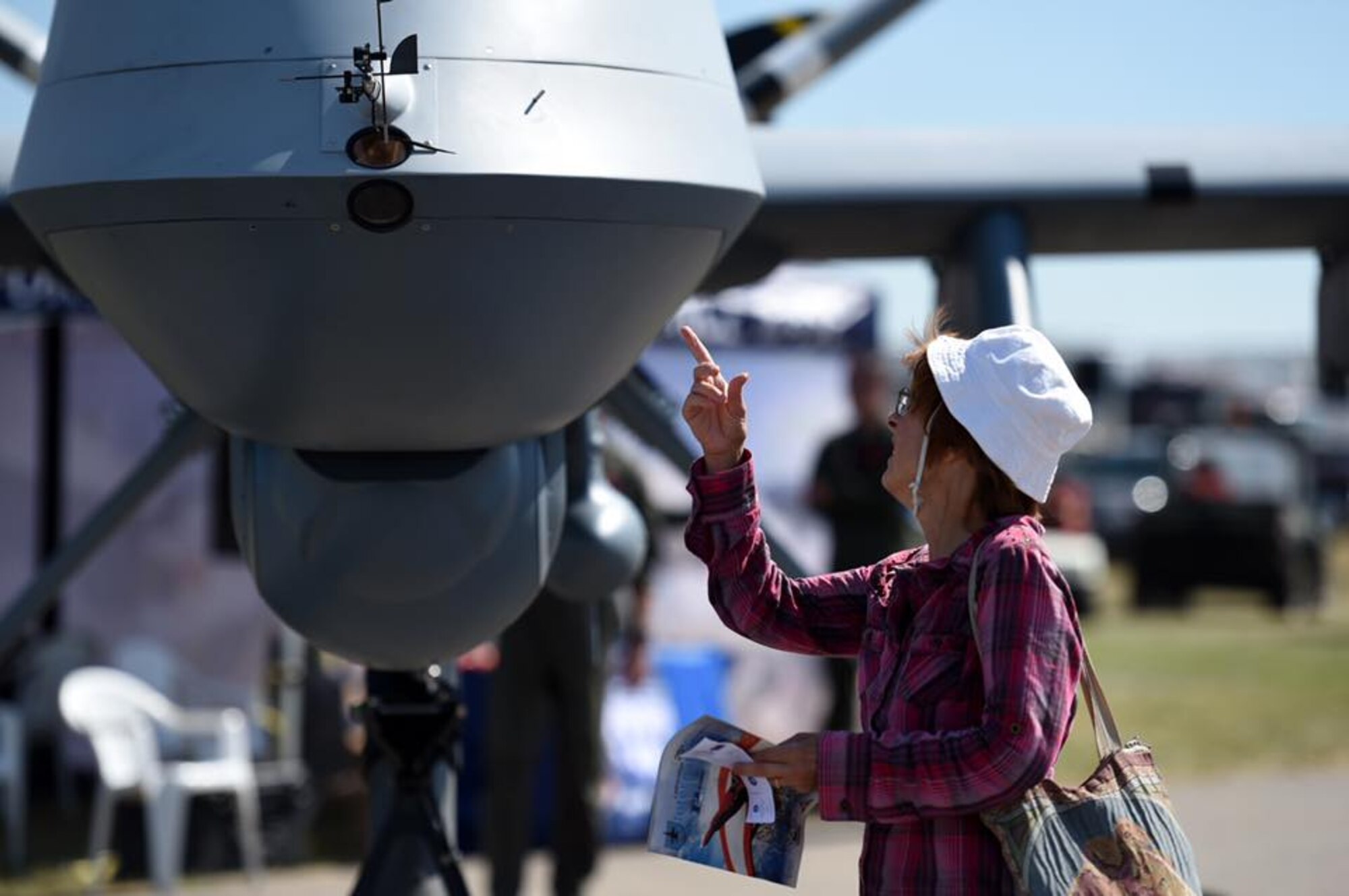 A Canadian citizen looks at the MQ-9 Reaper July 15, 2017, during the Lethbridge International Air Show in Alberta, Canada. The MQ-9 Reaper was on display as part of the partnership efforts between the U.S. and Canada. Airmen briefed spectators on the Reaper's multi-role capabilities, its maintenance and munitions specifications. (U.S. Air Force photo by Master Sgt. Nadine Barclay)