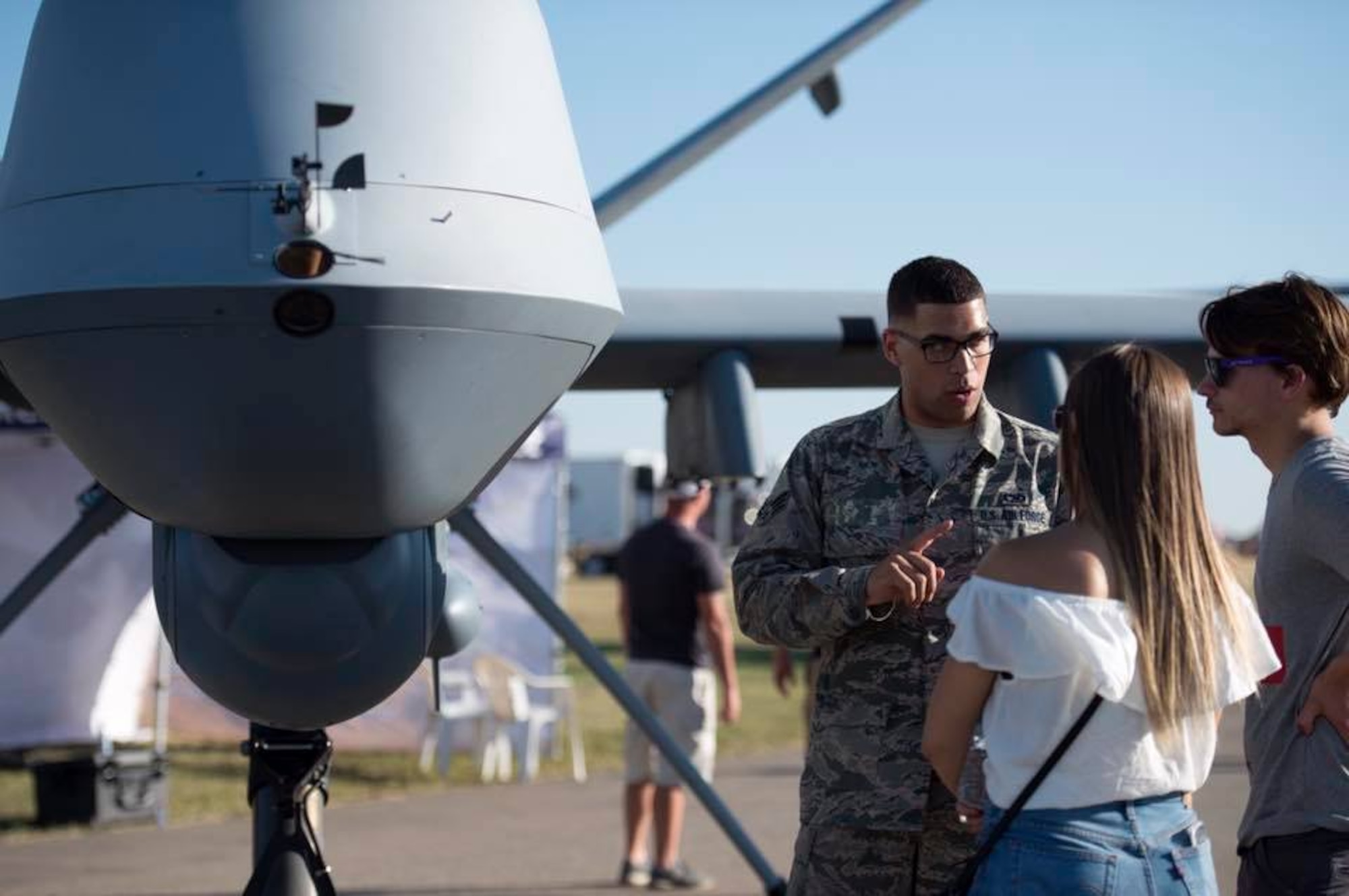 Senior Airman Benjamin, 432nd Aircraft Maintenance Squadron avionics journeyman, brief Canadian locals at the Lethbridge International Air Show July 14-16, 2017, in Alberta, Canada. The air show included various air demonstrations and statics from both Canada and the U.S. and featured representation of the U.S. Navy, Marines, and Army services. (U.S. Air Force photo/Master Sgt. Nadine Barclay)