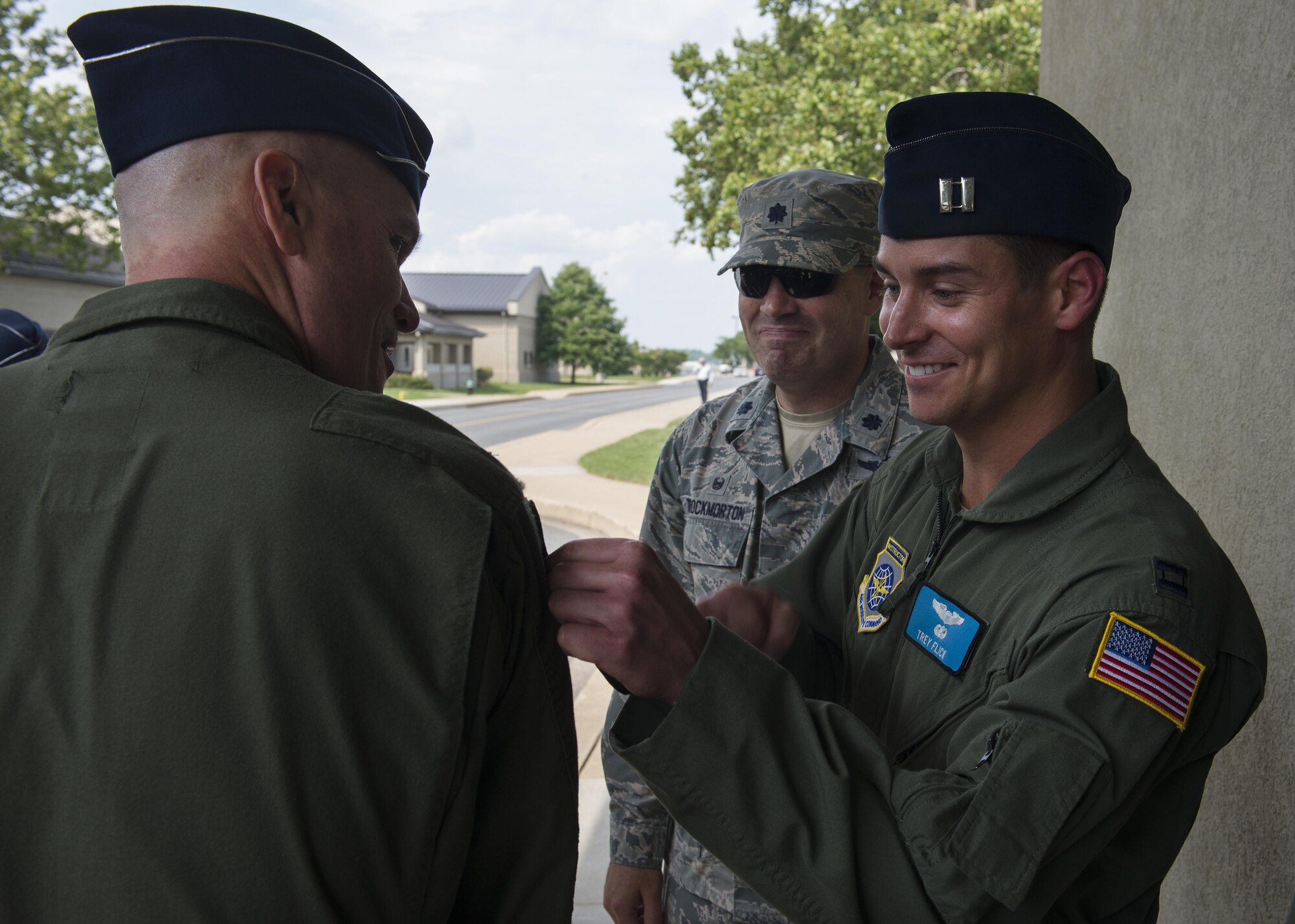 Capt. Trey Flick, 9th Airlift Squadron, places a 9th AS patch onto the shoulder of Gen. Carlton D. Everhart II, Air Mobility Command commander, during a base tour July 13, 2017, at Dover Air Force Base, Del. The 9th AS, also known as the Proud Pelicans, is Team Dover’s active duty squadron that operates the base’s fleet of C-5M Super Galaxy airlifters, providing rapid global mobility. (U.S. Air Force photo by Senior Airman Zachary Cacicia)