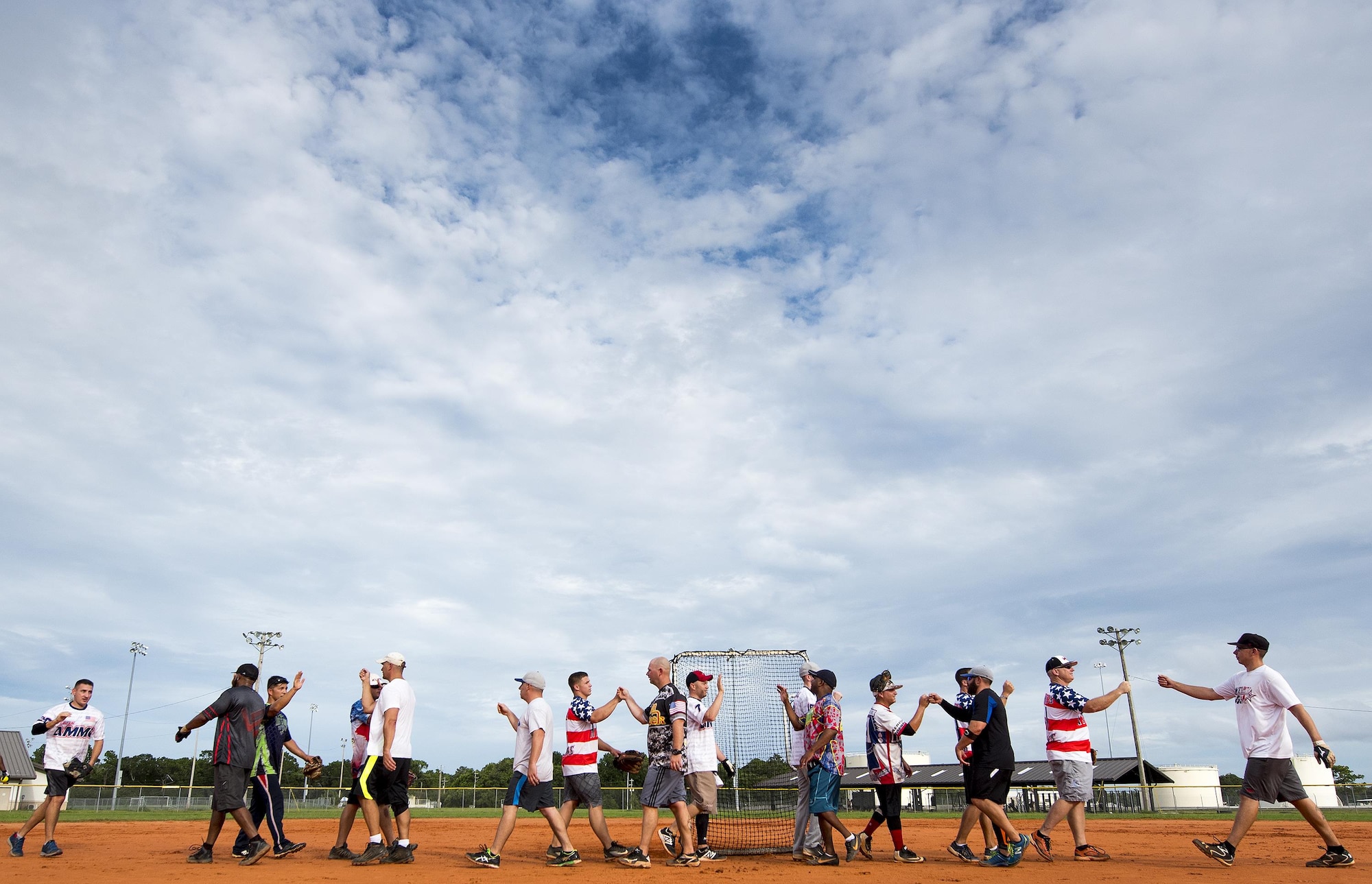 Members of the 96th Maintenance Squadron and the 359th Training Squadron intramural softball teams greet each other in the middle of the field after their game July 17 at Eglin Air Force Base, Fla.  The league-leading Maintainers pounded the training squadron 10-5 to improve to 9-1 on the season.  (U.S. Air Force photo/Samuel King Jr.)