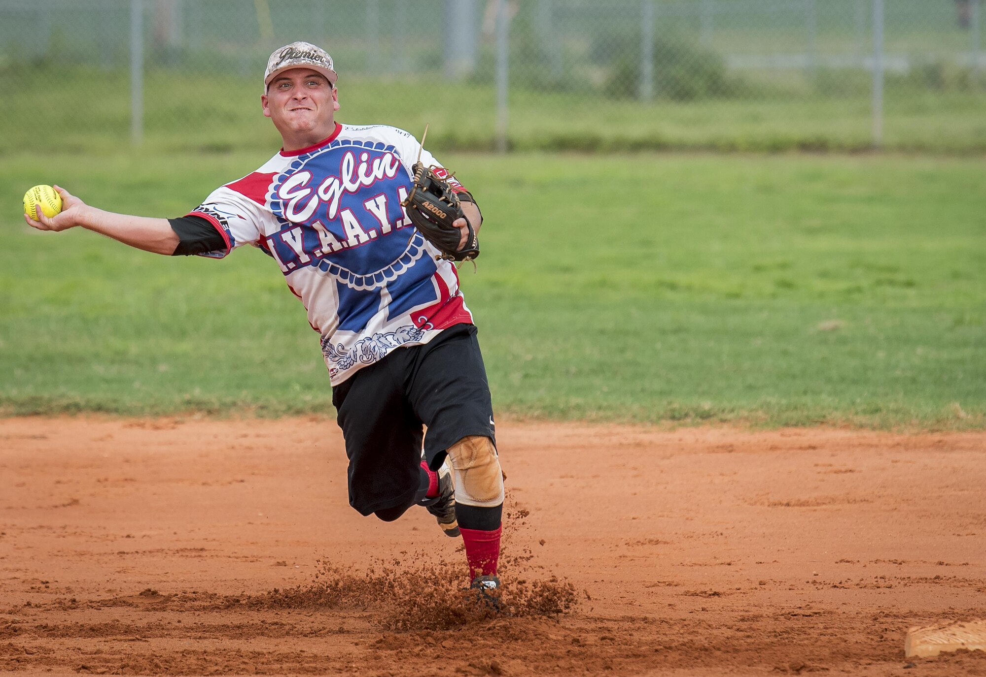 Tyler Leemon, 96th Maintenance Squadron softball team shortstop, slings a throw to first base during an intramural game against the 359th Training Squadron team July 17 at Eglin Air Force Base, Fla.  The league-leading Maintainers pounded the training squadron 10-5 to improve to 9-1 on the season.  (U.S. Air Force photo/Samuel King Jr.)