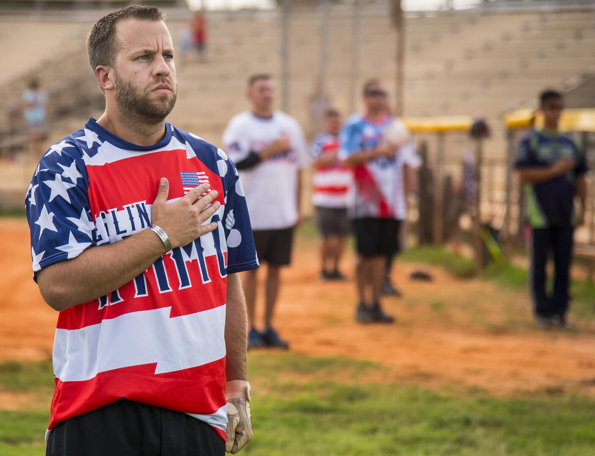 Kris Hampton, 96th Maintenance Squadron, stands with his hand over his heart during the National Anthem prior to his team’s intramural softball game against the 359th Training Squadron team July 17 at Eglin Air Force Base, Fla.  The league-leading Maintainers pounded the training squadron 10-5 to improve to 9-1 on the season.  (U.S. Air Force photo/Samuel King Jr.)