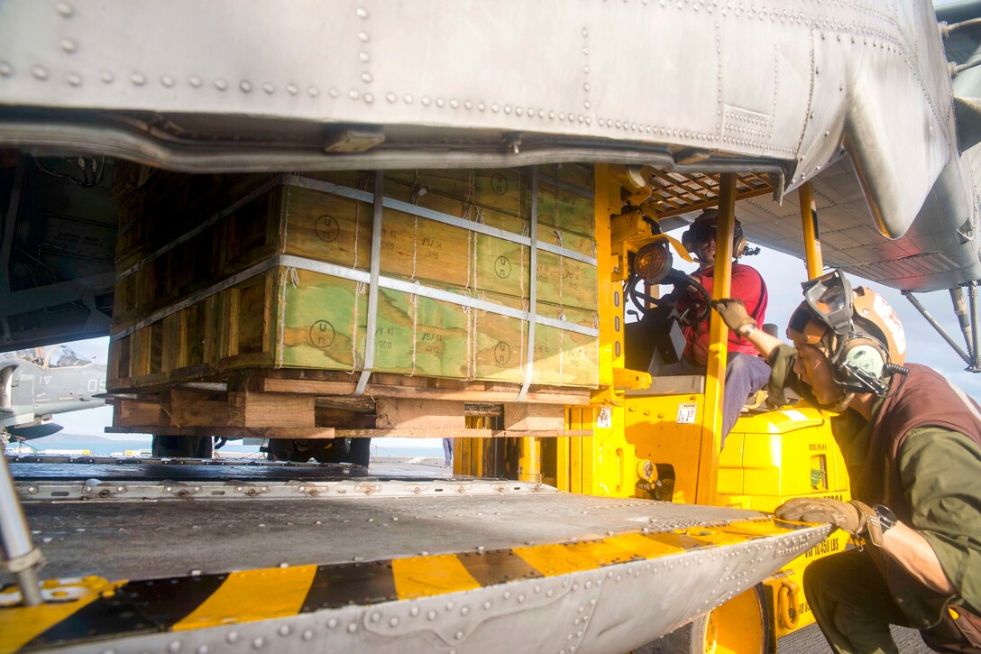 Sailors and Marines load ordnance into a CH-53E Super Stallion helicopter from the flight deck of the amphibious assault ship USS Bonhomme Richard as part of a large-scale amphibious assault during exercise Talisman Saber 17 in the Coral Sea, July 13, 2017. Navy photo by Petty Officer 3rd Class William Sykes