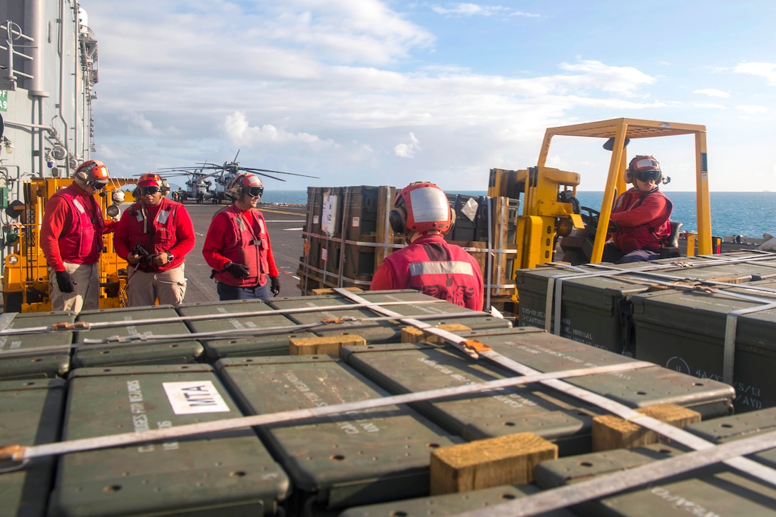 Sailors transport ordnance on the flight deck of the amphibious assault ship USS Bonhomme Richard as part of a large-scale amphibious assault during exercise Talisman Saber 17 in the Coral Sea, July 13, 2017. Navy photo by Petty Officer 3rd Class William Sykes