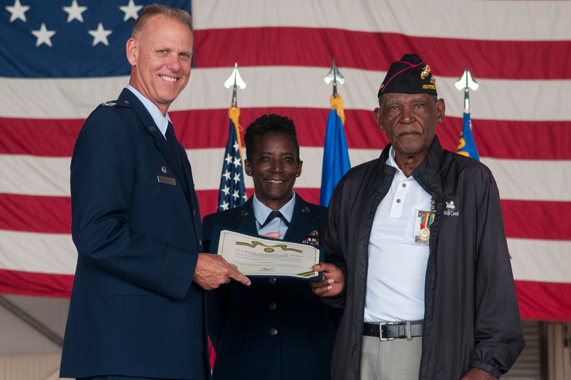 Col. Larry Shaw, 434th Air Refueling Wing commander, and Chief Master Sgt. Tamara Jones, 434th Logistics Readiness Squadron superintendent, present Albert Burdett, a retired Marine, with a Presidential Unit Citation during Jones’ retirement at Grissom Air Reserve Base, Ind. July 8, 2017. The award recognizes Burdett and his unit for their work and sacrifices during the Vietnam War. (U.S. Air Force photo/Staff Sgt. Dakota Bergl)