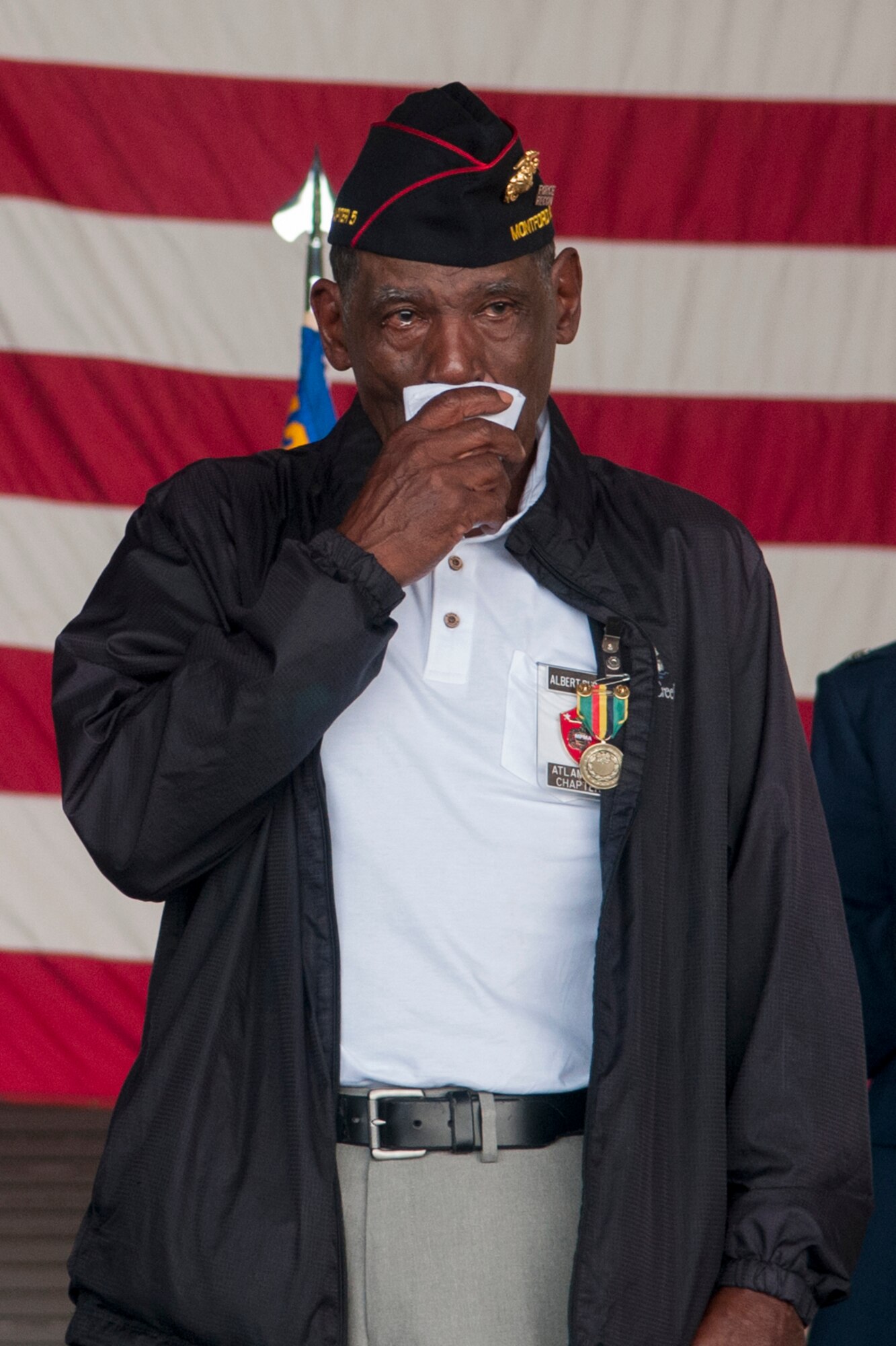 Albert Burdett, a retired Marine, fights back tears after being given a Presidential Unit Citation during his niece’s retirement ceremony at Grissom Air Reserve Base, Ind. July 8, 2017. Burdett received several awards during the Vietnam War but was never presented with them. (U.S. Air Force photo/Staff Sgt. Dakota Bergl)