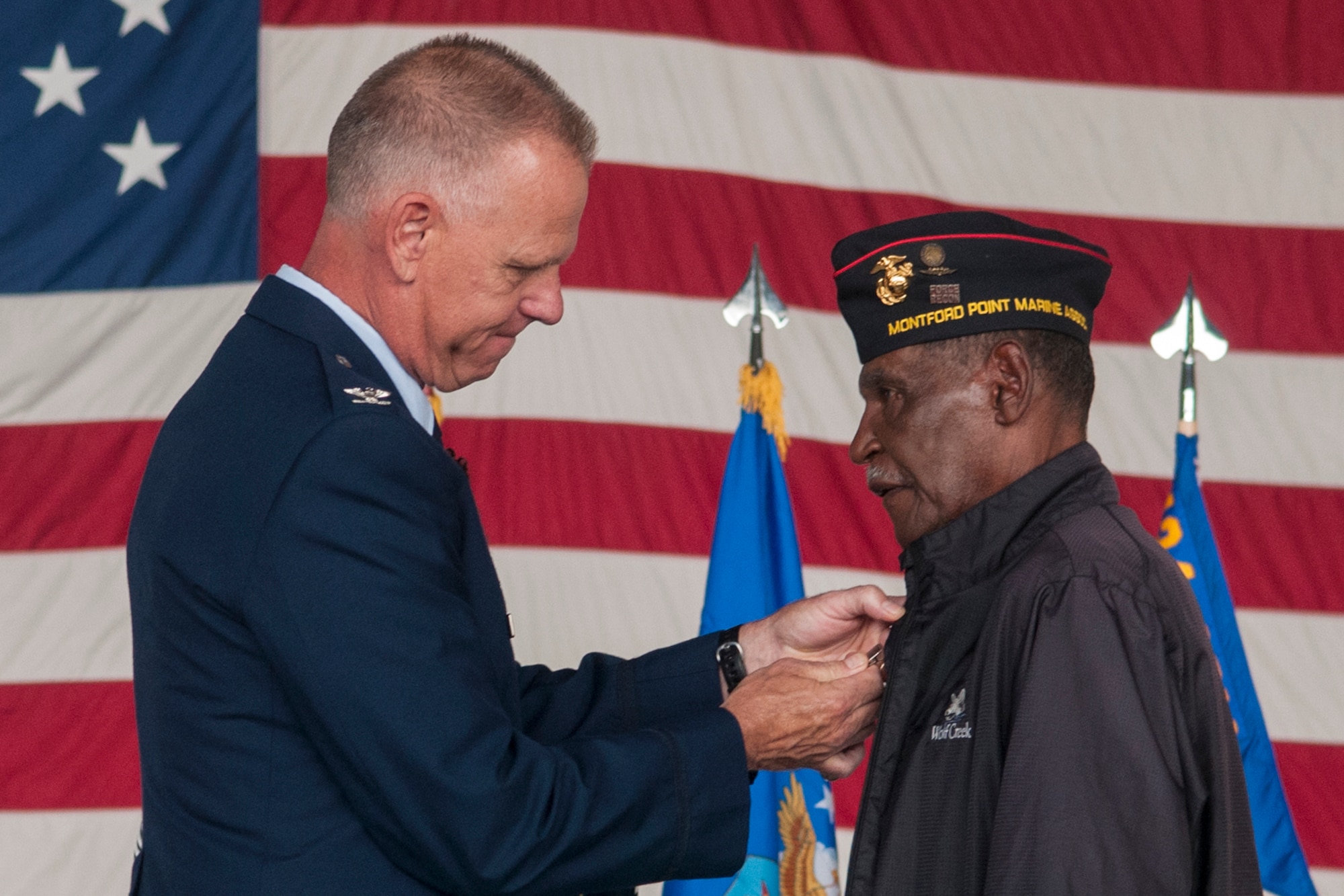 Col. Larry Shaw, 434th Air Refueling Wing commander, pins a medal on Albert Burdett, a retired Marine during a ceremony at Grissom Air Reserve Base, Ind. July 8, 2017.  Chief Master Sgt. Tamara Jones, 434th Logistics Readiness Squadron superintendent, requested that her uncle be presented with the award he earned during the Vietnam War as a part of her retirement ceremony. (U.S. Air Force photo/Staff Sgt. Dakota Bergl)