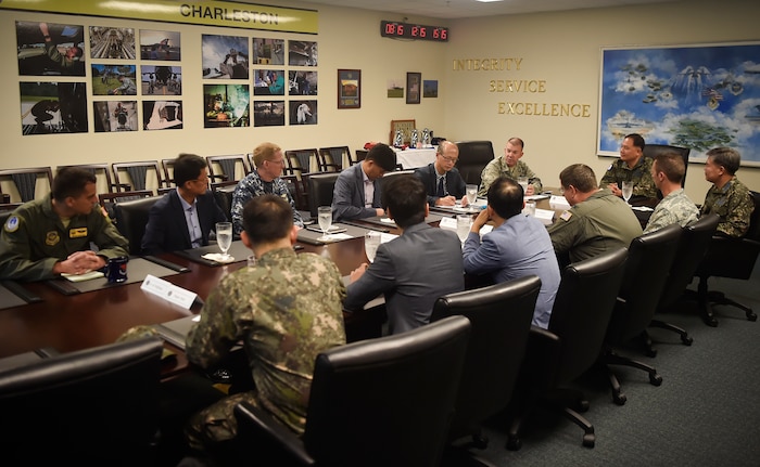 U.S. Air Force Col. Patrick Winstead, 437th Airlift Wing vice commander, briefs Republic of Korea members of the U.S. Air Transportation Working Group on the joint base mission during a visit here July 13. The engagement was part of an annual meeting in support of the Mutual Airlift Support Agreement. U.S. - ROK ATWG members toured a C-17 Globemaster III and observed an aeromedical evacuation demonstration during the event. (U.S. Air Force photo by Staff Sgt. Christopher Hubenthal)