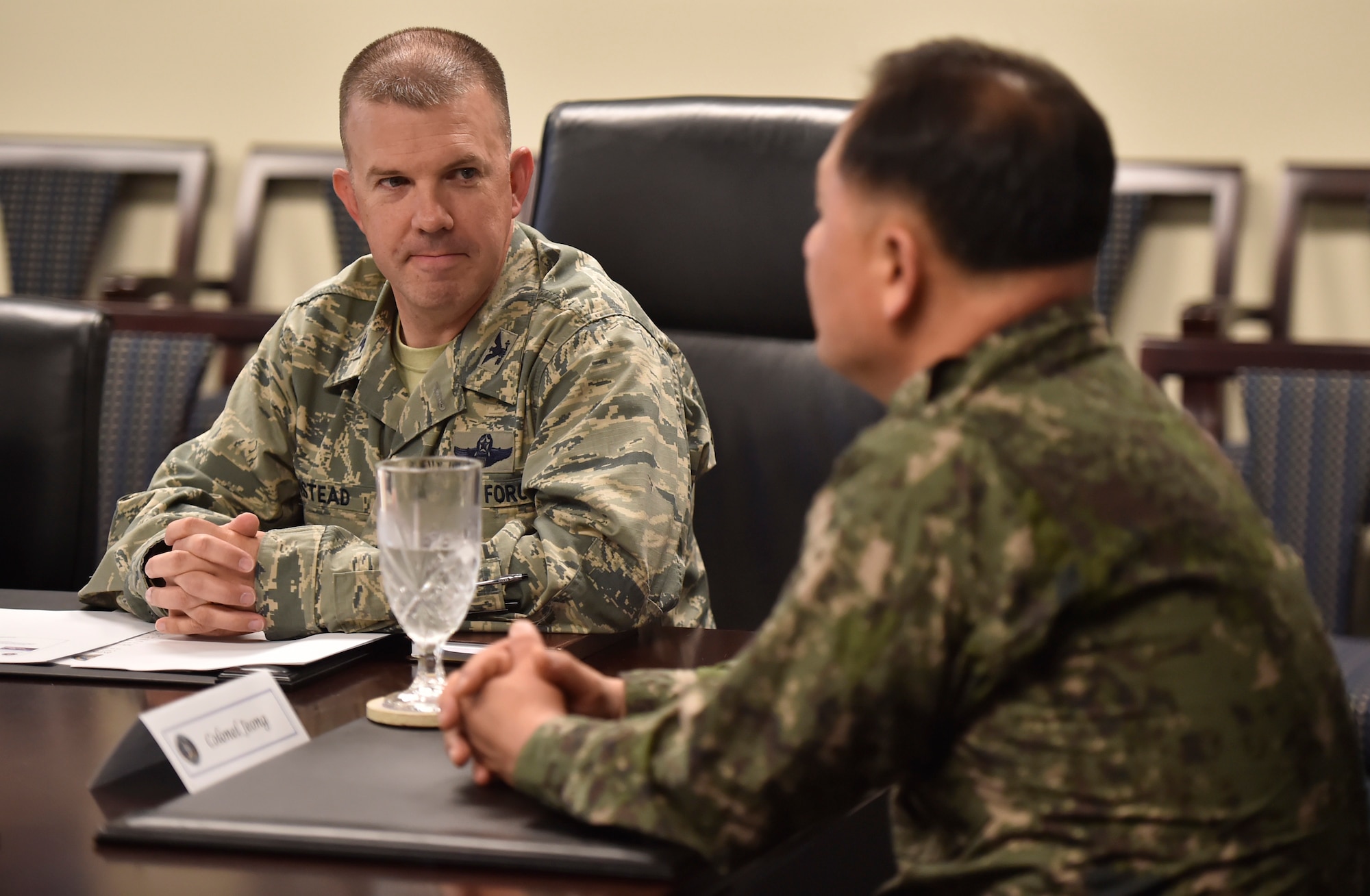 U.S. Air Force Col. Patrick Winstead, left, 437th Airlift Wing vice commander, talks to Col. Heon Jeong, right, Republic of Korea Air Force Headquarters transportation branch chief,  and ROK members of the U.S. Air Transportation Working Group, during a joint base mission briefing here July 13. The engagement was part of an annual meeting in support of the Mutual Airlift Support Agreement. U.S. - ROK ATWG members toured a C-17 Globemaster III and observed an aeromedical evacuation demonstration during the event. 