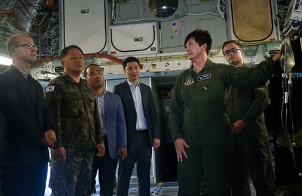 U.S. Air Force Capt. Charis Vincent, right, 315th Aeromedical Evacuation Squadron, briefs Col. Heon Jeong, center left, Republic of Korea Air Force Headquarters transportation branch chief, and ROK members of the U.S. Air Transportation Working Group, during a visit here July 13. The engagement was part of an annual meeting in support of the Mutual Airlift Support Agreement. U.S. - ROK ATWG members toured a C-17 Globemaster III and observed an aeromedical evacuation demonstration during the event. (U.S. Air Force photo by Staff Sgt. Christopher Hubenthal)