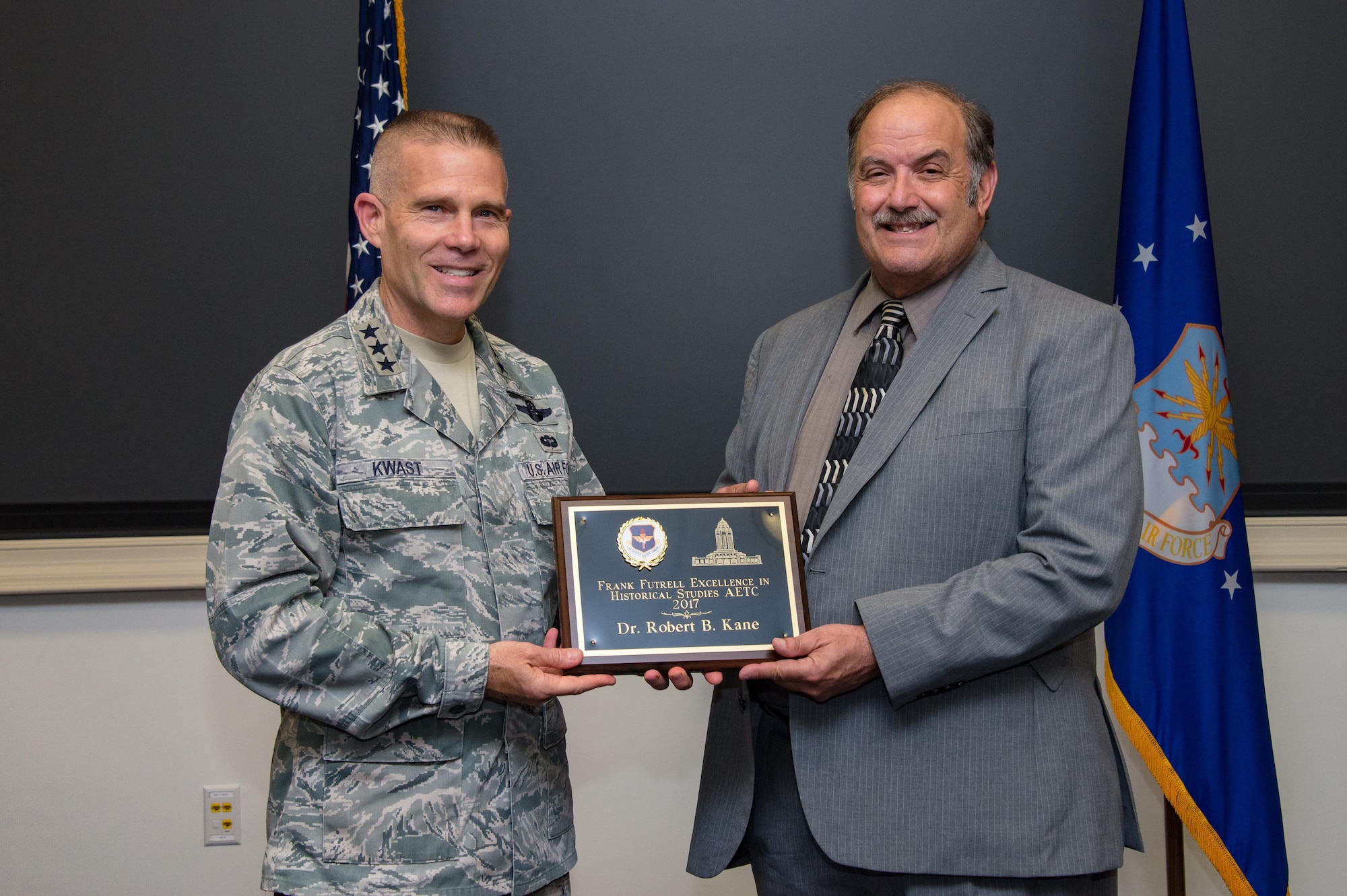 Lt. Gen. Steven Kwast, Air University commander and president presents the 2017 Air Education and Training Command’s Frank Futrell Excellence in Historical Studies award to Dr. Robert Kane, AU historian, July 14, 2017, Maxwell Air Force Base, Ala. Kane was recognized for his book titled, “So Far from Home Royal Air Force and Free French Air Force Flight Training at Maxwell and Gunter Fields during World War II.”(U.S. Air Force photo/ Melanie Rodgers Cox)