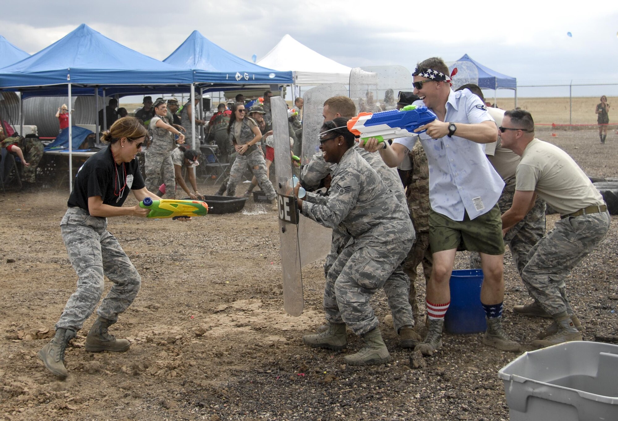 Team Buckley members enjoy a Combat Dining Out hosted July 14, 2017, at Camp Rattlesnake on Buckley Air Force Base, Colo. The Combat Dining Out paid tribute to 70 years of Air Force History, while giving members an opportunity to build morale and esprit de corps with their fellow wingmen. (U.S. Air Force photo by Tech. Sgt. Nicholas Rau)