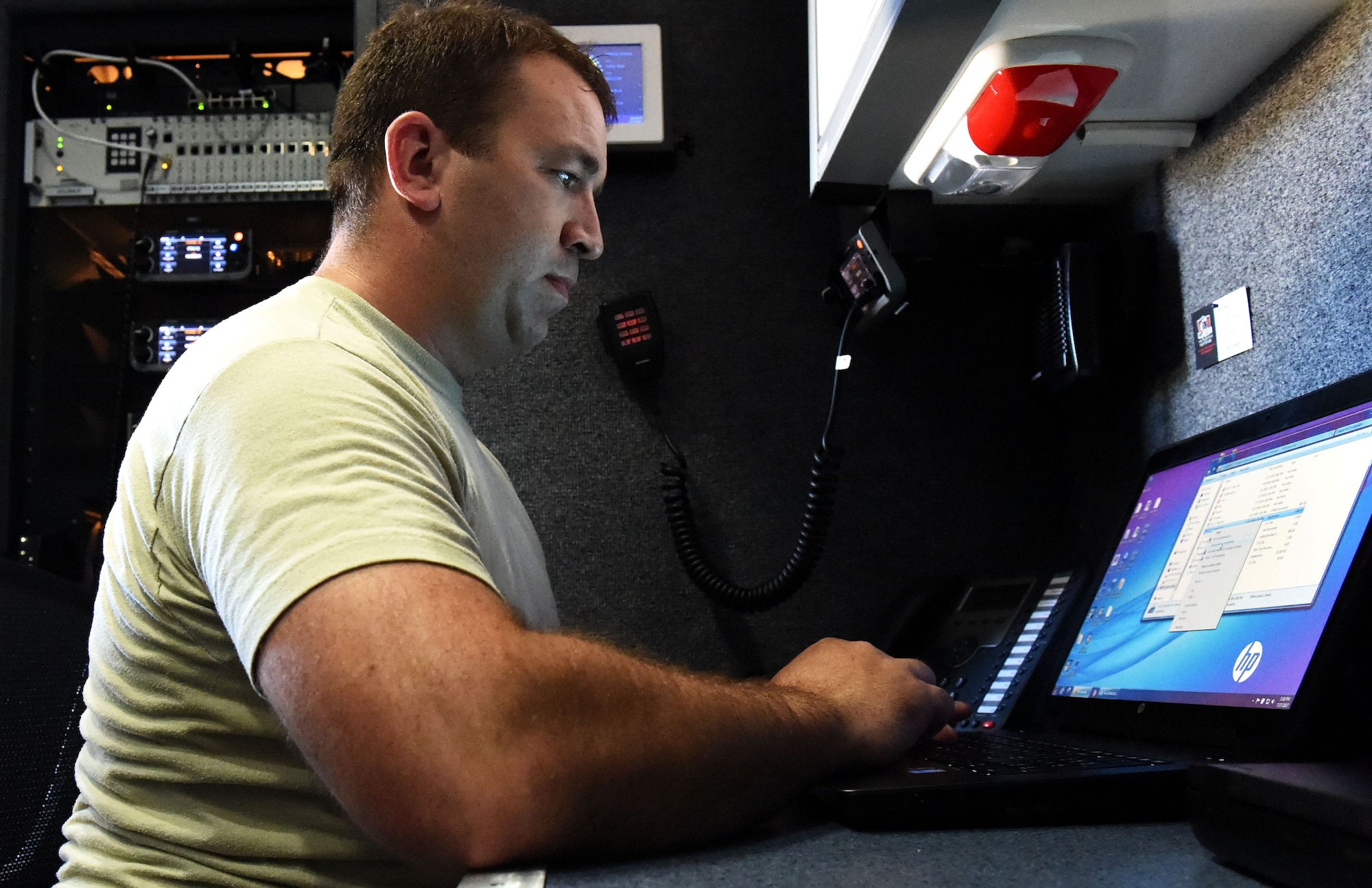 Master Sgt. Brad Kuennen, a Radio Frequency Transmissions Systems Technician, starts up the laptop at his station in the 132d Wing's Mobile Emergency Operations Center (MEOC) on July 17, 2017 at Fort McCoy, Wis. Kuennen can set up radio frequencies from this laptop and controls all radio patches from the MEOC in support of PATRIOT North 2017. (U.S. Air National Guard photo by A1C Katelyn Sprott)
