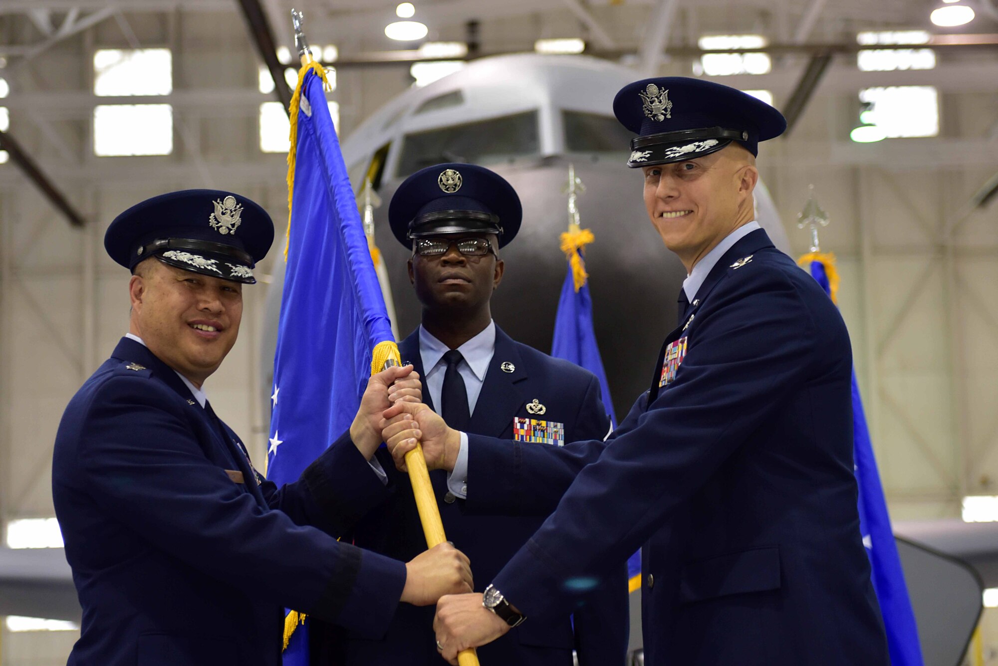 Lt. Gen. Giovanni Tuck, 18th Air Force commander, passes the 22nd Air Refueling Wing guidon to Col. Joshua Olson, the incoming 22nd ARW commander, during the change of command ceremony, July 18, 2017, at McConnell Air Force Base, Kan. Olson took command of the 22nd ARW after a year-long deployment to the Middle East. (U.S. Air Force photo/Staff Sgt. Trevor Rhynes) 