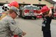 Families gather around to watch a demonstration of a TI-1500 Aircraft Rescue and Firefighting Vehicle (ARFF) during a fire department open house July 15, 2017, at Eielson Air Force Base, Alaska. The TI-1500 ARFF is used to respond to aircraft incidents and can carry both water and foam for fighting fires. (U.S. Air Force photo by Airman Eric M. Fisher)