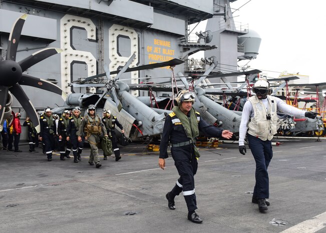 BAY OF BENGAL (July 17, 2017) Indian Navy Rear Admiral Biswajit Dasgupta, flag officer commanding Eastern Fleet, transits the flight deck as he prepares to depart the aircraft carrier USS Nimitz (CVN 68), marking the conclusion of Exercise Malabar 2017, July 17, 2017 in the Bay of Bengal. Malabar 2017 is the latest in a continuing series of exercises between the Indian Navy, Japan Maritime Self-Defense Force and U.S. Navy that has grown in scope and complexity over the years to address the variety of shared threats to maritime security in the Indo-Asia-Pacific region. (U.S. Navy photo by Mass Communication Specialist 2nd Class Holly L. Herline)
