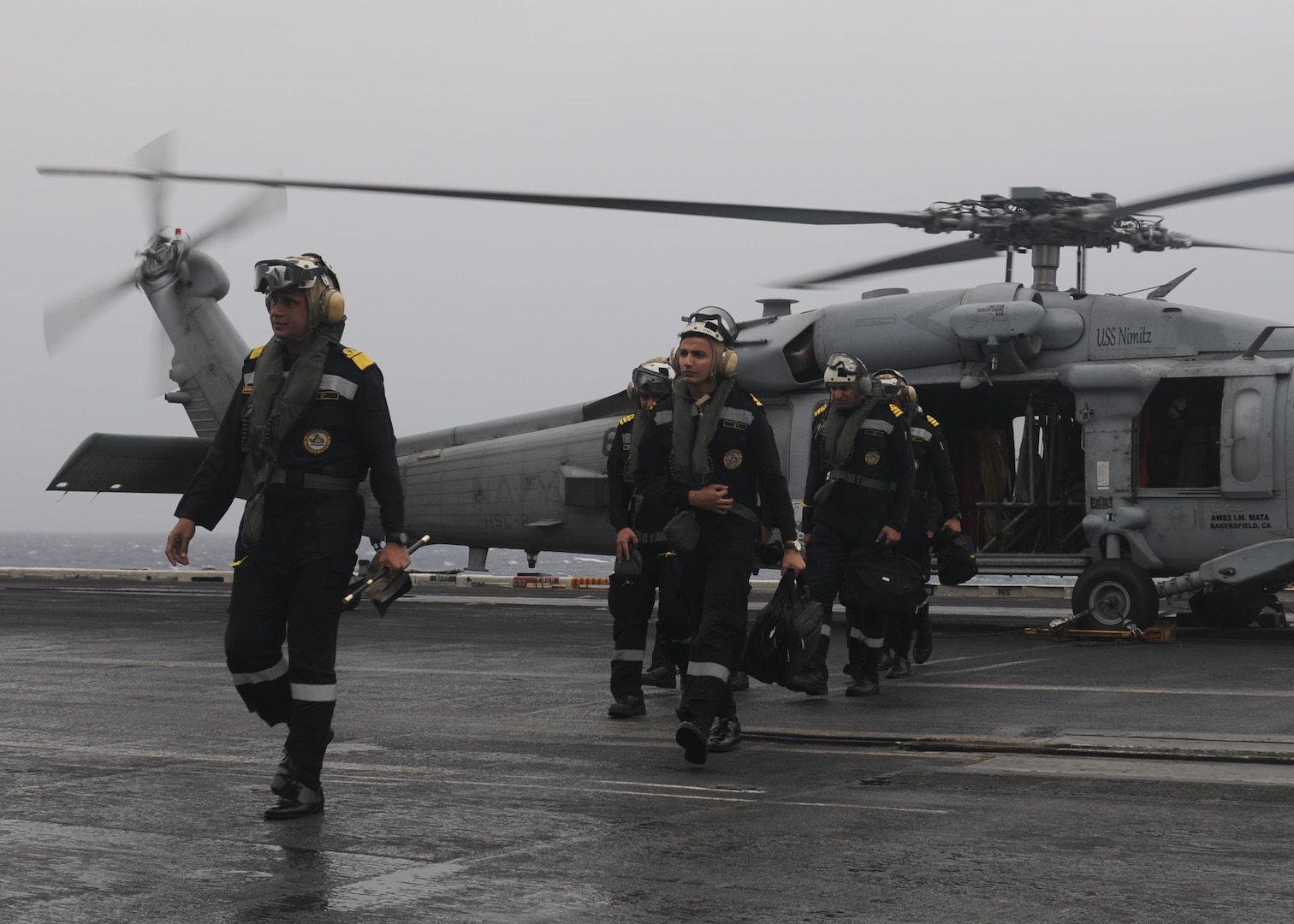 BAY OF BENGAL (July 17, 2017) Indian Navy Rear Admiral Biswajit Dasgupta, flag officer commanding eastern fleet, transits the flight deck of the aircraft carrier USS Nimitz (CVN 68) after arriving aboard via an MH-60R Seahawk helicopter from the "Eightballers" of Helicopter Sea Combat Squadron (HSC) 8 during an admiral visit as part of the conclusion of Exercise Malabar 2017, July 17, 2017 in the Bay of Bengal. Malabar 2017 is the latest in a continuing series of exercises between the Indian Navy, Japan Maritime Self-Defense Force and U.S. Navy that has grown in scope and complexity over the years to address the variety of shared threats to maritime security in the Indo-Asia-Pacific region. (U.S. Navy photo by Mass Communication Specialist 2nd Class Holly L. Herline)