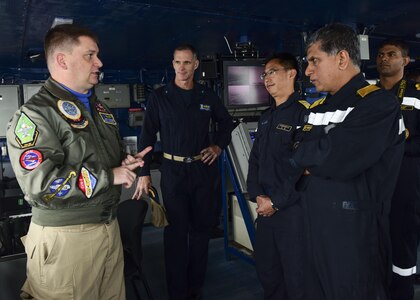 BAY OF BENGAL (July 17, 2017) U.S. Navy Rear Adm. Bill Byrne, commander of Carrier Strike Group 11, middle left, Japan Maritime Self-Defense Force Rear Admiral Yoshihiro Goka, commander of Escort Flotilla One, middle right, and Indian Navy Rear Admiral Biswajit Dasgupta, flag officer commanding Eastern Fleet, receive a tour of primary flight control from Cmdr. Corey Plocher, the Air Boss aboard the aircraft carrier USS Nimitz (CVN 68) during an admirals visit as part of the conclusion of Exercise Malabar 2017, July 17, 2017 in the Bay of Bengal. Malabar 2017 is the latest in a continuing series of exercises between the Indian Navy, Japan Maritime Self-Defense Force and U.S. Navy that has grown in scope and complexity over the years to address the variety of shared threats to maritime security in the Indo-Asia-Pacific region. (U.S. Navy photo by Mass Communication Specialist 2nd Class Holly L. Herline)