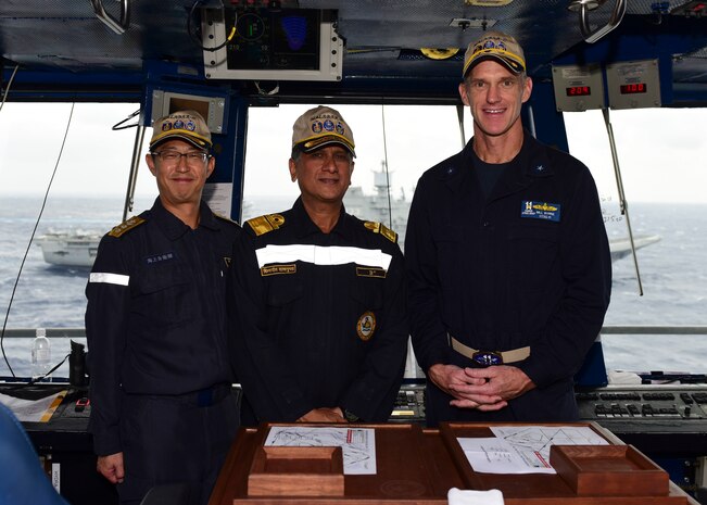 BAY OF BENGAL (July 17, 2017) Japan Maritime Self-Defense Force (JMSDF)  Rear Admiral Yoshihiro Goka, commander of Escort Flotilla One, left, Indian Navy Rear Admiral Biswajit Dasgupta, flag officer commanding Eastern Fleet, middle, and U.S. Navy Rear Adm. Bill Byrne, commander of Carrier Strike Group 11, pose for a photo in primary flight control aboard the aircraft carrier USS Nimitz (CVN 68) during a formation sail as part of the conclusion of Exercise Malabar 2017, July 17, 2017 in the Bay of Bengal. Malabar 2017 is the latest in a continuing series of exercises between the Indian Navy, JMSDF and U.S. Navy that has grown in scope and complexity over the years to address the variety of shared threats to maritime security in the Indo-Asia-Pacific region. (U.S. Navy photo by Mass Communication Specialist 2nd Class Holly L. Herline)