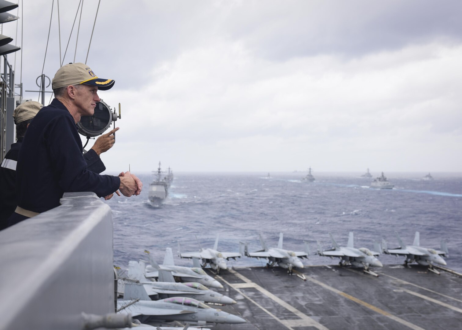 BAY OF BENGAL (July 17, 2017) U.S. Navy Rear Adm. Bill Byrne, commander of Carrier Strike Group 11, watches ships from the Indian Navy, Japan Maritime Self-Defense Force (JMSDF) and the U.S. Navy sail in formation from the aircraft carrier USS Nimitz (CVN 68) as part of the conclusion of Exercise Malabar 2017, July 17, 2017 in the Bay of Bengal. Malabar 2017 is the latest in a continuing series of exercises between the Indian Navy, JMSDF and U.S. Navy that has grown in scope and complexity over the years to address the variety of shared threats to maritime security in the Indo-Asia-Pacific region. (U.S. Navy photo by Mass Communication Specialist 2nd Class Holly L. Herline)