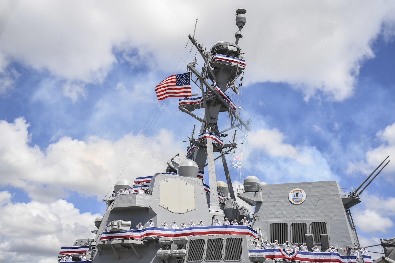 170715-N-WM477-0226 -- PEARL HARBOR (July 15, 2017) The crew of the Navy's newest Arleigh Burke-class guided-missile destroyer, USS John Finn (DDG 113) brings the ship to life during its commissioning ceremony. DDG 113 is named in honor of Lt. John William Finn, who as a chief aviation ordnanceman was the first member of our armed services to earn the Medal of Honor during World War II for heroism during the attack on Pearl Harbor. (U.S. Navy Photo by Mass Communication Specialist Aiyana Paschal)