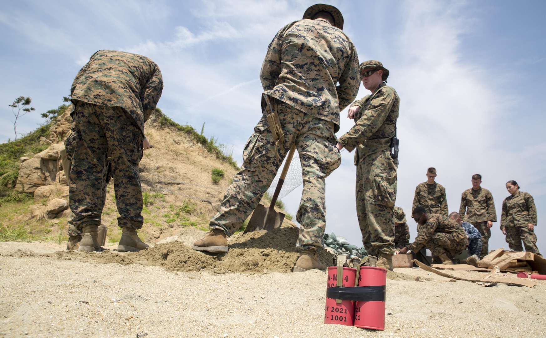 Explosive ordnance disposal Marines with Headquarters and Headquarters Squadron prepare to conduct a simulated gasoline explosion at Target Island, Marine Corps Air Station Iwakuni, Japan, July 14, 2017. The training prepares EOD Marines to handle explosive threats for any aircraft incident that may happen on the installation. (U.S Marine Corps photo by Lance Cpl. Carlos Jimenez)