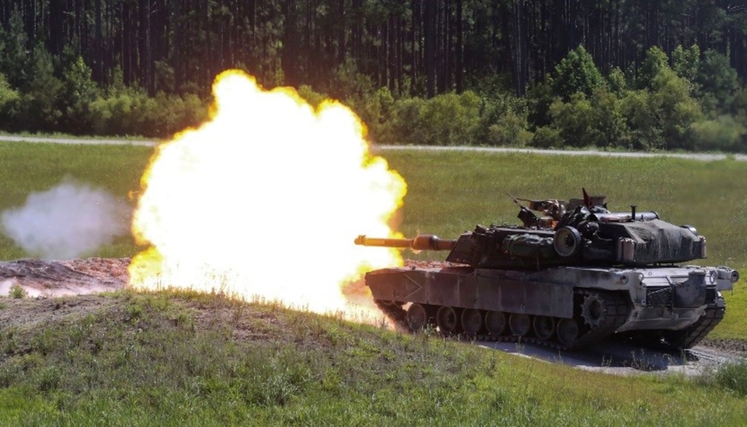 An M1A1 Abrams battle tank fires a round at a simulated target during a combined arms range for Iron Wolf 17 at Camp Lejeune, N.C., July 14, 2017. Iron Wolf 17 is a multi-unit exercise designed to simulate battlefield conditions Marines may face while deployed. The tanks are from 2nd Tank Battalion, 2nd Marine Division. (United States Marine Corps photo by Cpl. Jon Sosner)