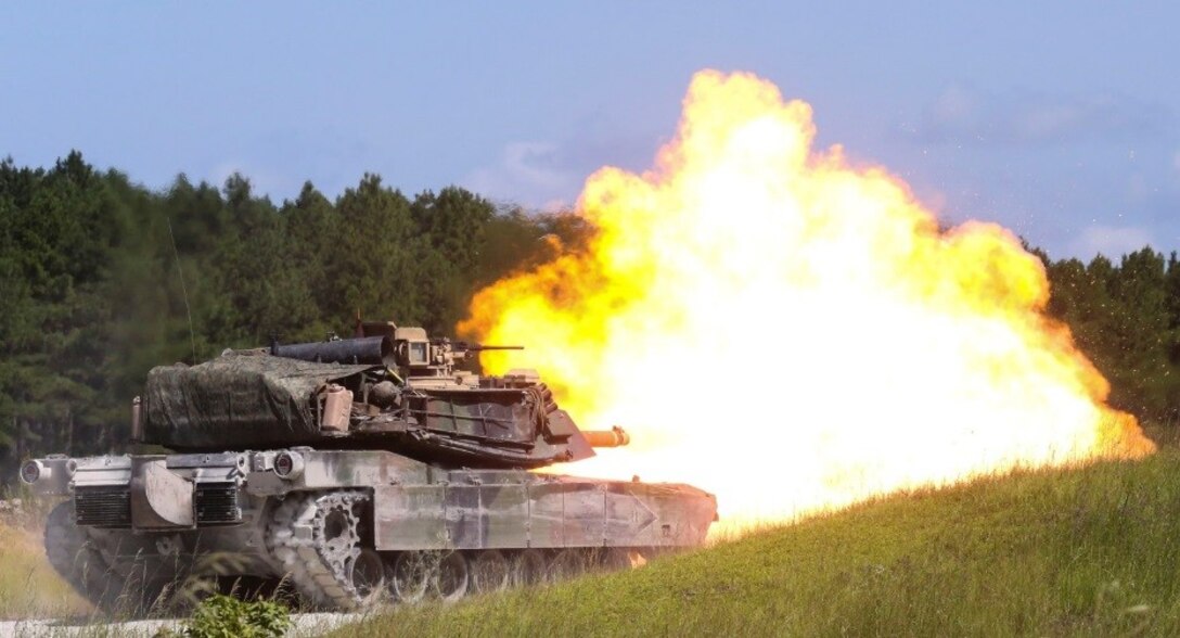 An M1A1 Abrams battle tank fires a round at a simulated target during a combined arms range for Iron Wolf 17 at Camp Lejeune, N.C., July 14, 2017. Iron Wolf 17 is a multi-unit exercise designed to simulate battlefield conditions Marines may face while deployed. The tanks are from 2nd Tank Battalion, 2nd Marine Division. (United States Marine Corps photo by Cpl. Jon Sosner)