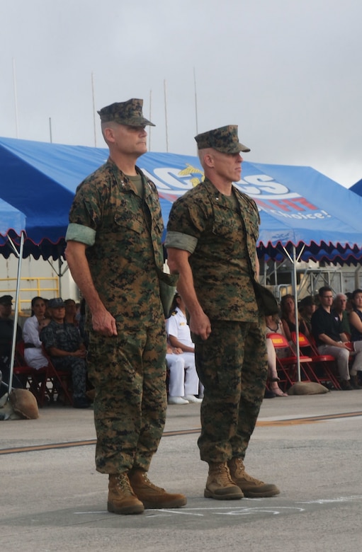 U.S. Marine Corps Maj. Gen. Russell A. Sanborn (left), outgoing 1st Marine Aircraft Wing commanding general, stands at attention with Brig. Gen. Thomas D. Weidley (right), the incoming commanding general, during a change of command ceremony at Marine Corps Air Station Futenma, Okinawa, Japan, June 29, 2017. Sanborn relinquished command to Weidley and will assume command at Marine Forces Europe and Africa. (U.S. Marine Corps photo by Lance Cpl. Isabella Ortega) 
