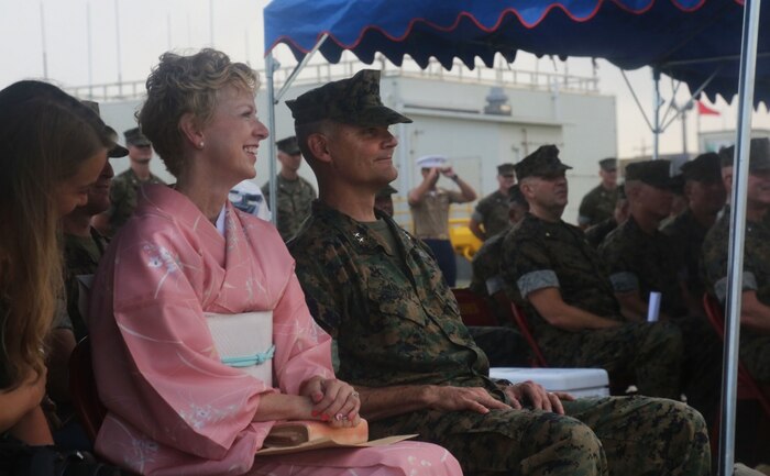 U.S. Marine Corps Maj. Gen. Russell A. Sanborn and his wife Linda Sanborn listen as Lt. Gen. Lawrence D. Nicholson speaks to the audience during a change of command ceremony at Marine Corps Air Station Futenma, Okinawa, Japan, June 29, 2017. Sanborn is the outgoing 1st Marine Aircraft Wing commanding general and Nicholson is the III Marine Expeditionary Force commanding general. Sanborn relinquished command to Brig. Gen. Thomas D. Weidley and will assume command of Marine Forces Europe and Africa. (U.S. Marine Corps photo by Lance Cpl. Isabella Ortega) 