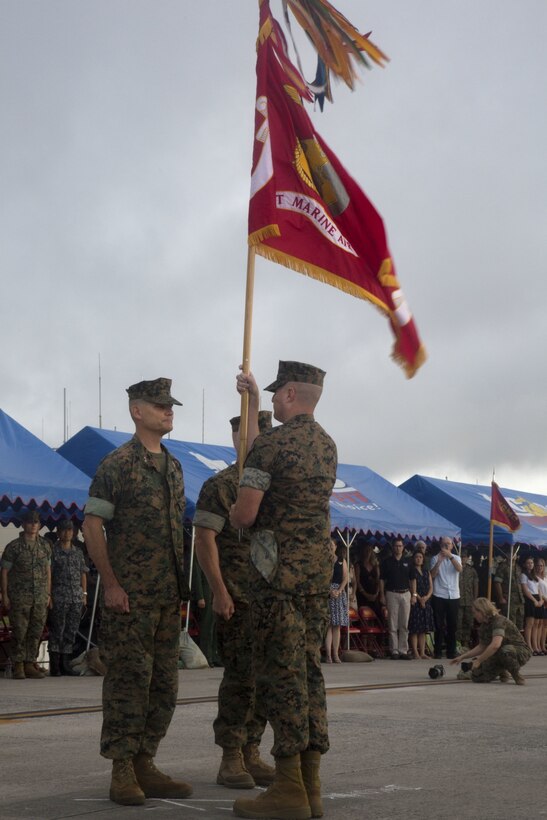 U.S. Marine Corps Sgt. Maj. Michael J. Pritchard passes the unit colors to Maj. Gen. Russell A. Sanborn, representing the passing of command during a change of command ceremony at Marine Corps Air Station Futenma, Okinawa, Japan, June 29, 2017. Sanborn, outgoing 1st Marine Aircraft Wing commanding general, relinquished command to Brig. Gen. Thomas D. Weidley and will assume command at Marine Forces Europe and Africa. (U.S. Marine Corps photo by Lance Cpl. Isabella Ortega)